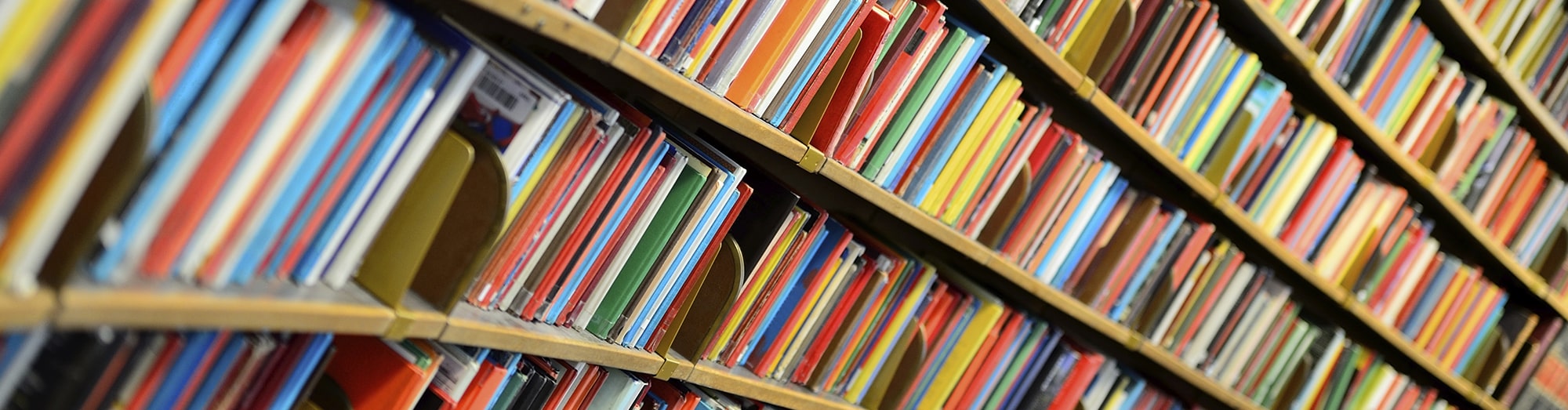 Colorful books lined up on a bookshelf
